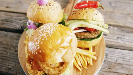 Hamburgers-and-french-fries-on-wooden-board
