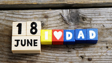 Date-and-blocks-arranged-on-wooden-plank