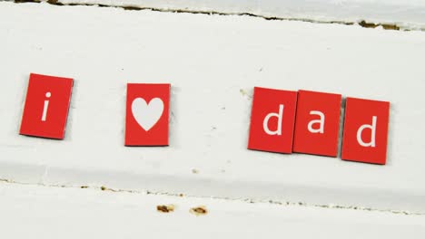 Text-I-love-dad-arranged-on-blocks-arranged-on-wooden-plank