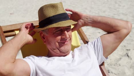 Senior-man-relaxing-on-beach-chair-at-beach