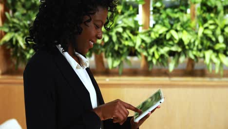 Businesswoman-using-digital-tablet-in-office