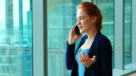 Female-executive-talking-on-mobile-phone