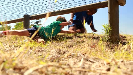 Boy-helping-his-friend-during-obstacle-course
