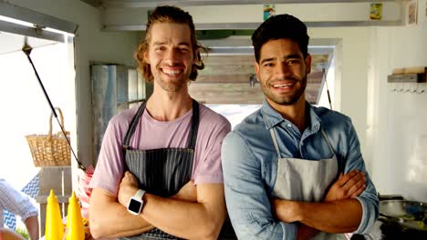 Portrait-of-waiters-standing-with-arms-crossed