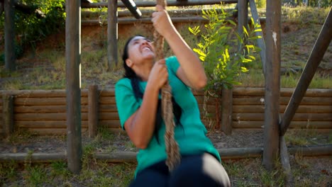 Fit-woman-climbing-the-rope-during-obstacle-course