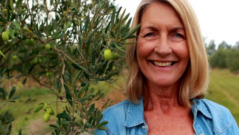 Portrait-of-happy-woman-standing-in-olive-farm-4k