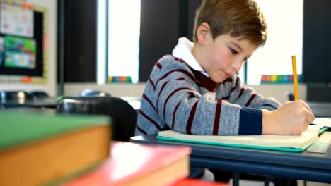 Boy-doing-homework-in-classroom-4k