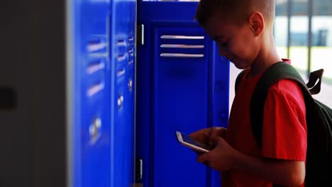 Schoolboy-using-mobile-phone-in-locker-room-4k
