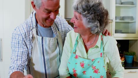 Senior-couple-using-digital-tablet-in-kitchen-4k