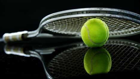 Tennis-ball-and-racket-in-studio-4k