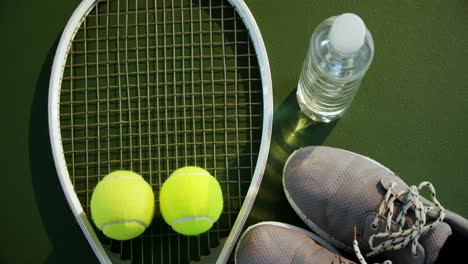Water-bottle,-sports-shoes-and-sports-equipment-in-tennis-court-4k