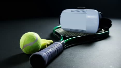 Tennis-balls,-racket-and-virtual-reality-headset-in-studio-4k