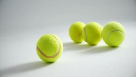 Tennis-balls-arranged-on-white-background-4k