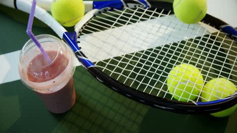 Milkshake-and-sports-equipment-in-tennis-court-4k
