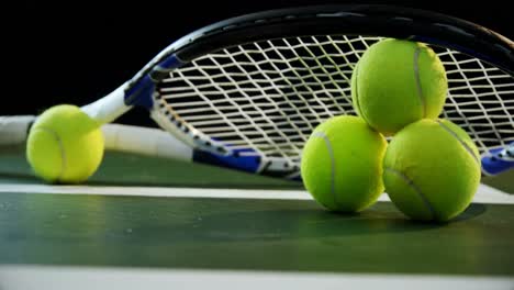 Close-up-racket-arranged-on-tennis-balls-4k