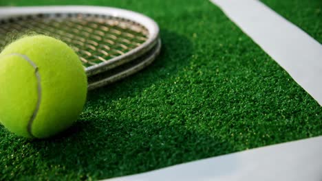 Close-up-of-tennis-ball-and-racket-near-white-line-4k