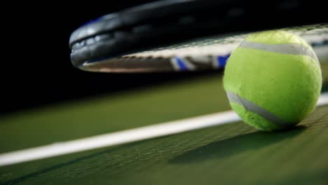 Racket-and-tennis-ball-in-court-4k