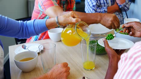 Senior-friends-having-breakfast-on-dining-table-4k