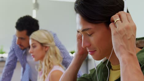 Happy-executive-listening-music-on-headphones-at-desk-4k
