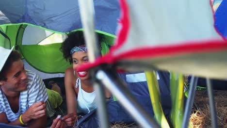 Couple-lying-on-tent-at-music-at-music-festival-4k
