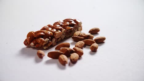 Granola-bar-and-almond-on-white-background-4k