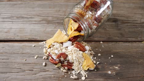 Homemade-granola-spilling-from-jar-4k