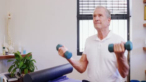 Senior-man-exercising-with-dumbbells-4k
