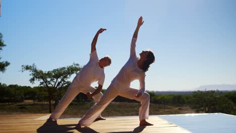 Couple-doing-yoga-in-resort-4k