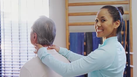 Portrait-of-happy-physiotherapist-giving-neck-massage-to-senior-patient-4k