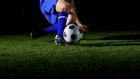 Soccer-player-performing-a-sliding-tackle-on-playing-field-4k