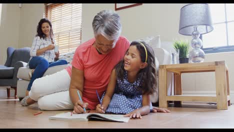Grandmother-and-granddaughter-coloring-book-in-living-room-4k