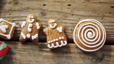 Various-cookies-and-candy-cane-arranged-on-wooden-table-4k