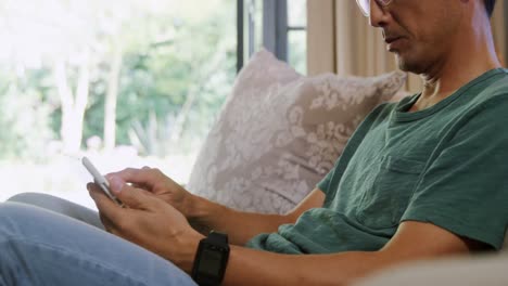 Man-using-digital-tablet-in-living-room-4k