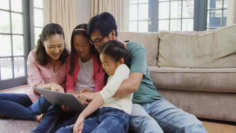 Family-using-laptop-together-in-living-room-4k
