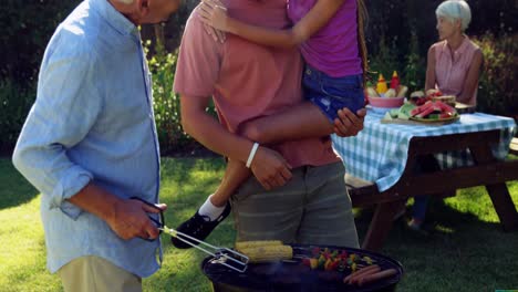 Happy-girl,-father-and-grandfather-preparing-barbecue-4k