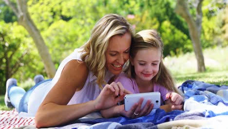 Mother-and-daughter-taking-selfie-with--mobile-phone-in-park-4k
