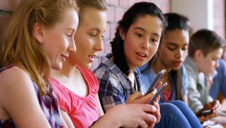 Group-of-school-friends-using-mobile-phone-4k