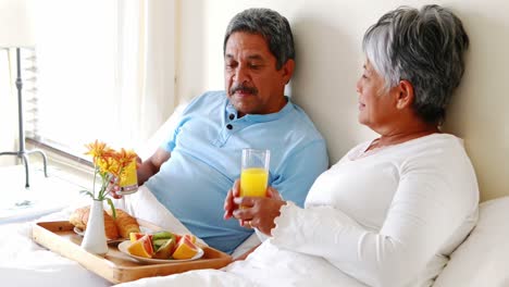 Senior-couple-having-breakfast-in-the-bedroom-4k