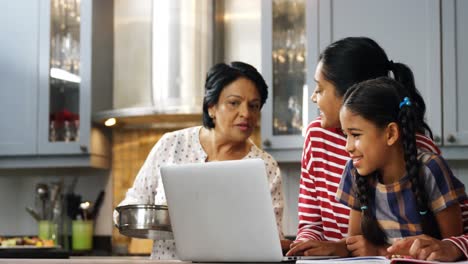 Multi-generation-family-using-laptop-in-kitchen-4k-