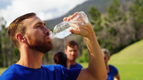 Man-drinking-water-in-boot-camp-4k