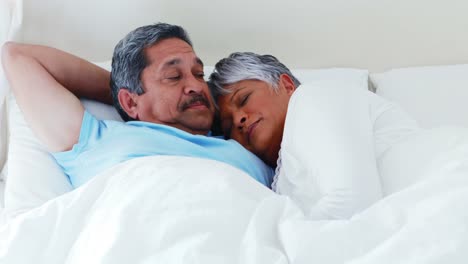Senior-couple-relaxing-in-bedroom-4k