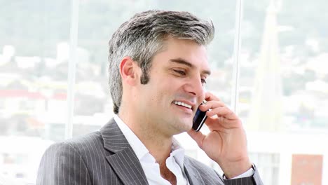 Mature-businessman-calling-by-phone