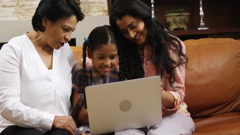 Multi-generation-family-using-laptop-in-living-room-4k