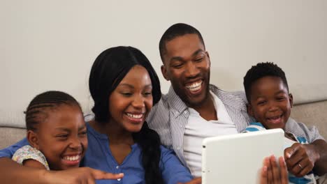 Family-using-digital-tablet-in-living-room-4k