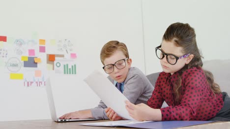 Kids-as-business-executive-working-at-desk-4k
