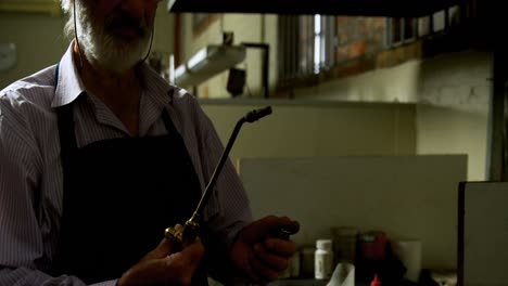 Goldsmith-lighting-welding-torch-in-workshop-4k