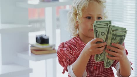 Kid-as-business-executive-counting-currency-note-4k