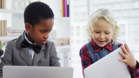 Niños-Como-Ejecutivos-De-Negocios-Discutiendo-Sobre-Una-Computadora-Portátil-4k