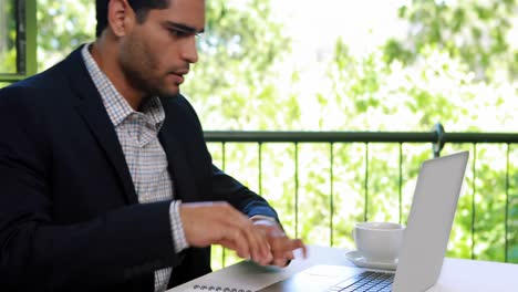 Businessman-using-laptop-in-restaurant-4k