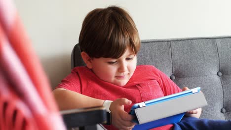 Boy-using-digital-tablet-in-living-room-4k